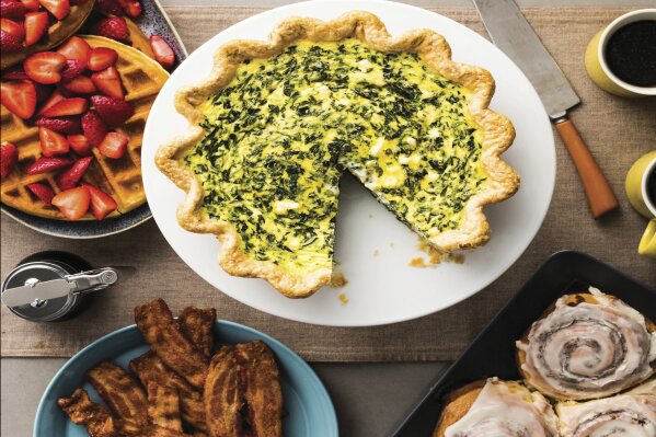 
              This image provided by America's Test Kitchen in October 2018 shows the cover for the cookbook “ATB Brunch.” It includes a recipe for a leek and goat cheese quiche and a cider-glazed apple bundt cake. (America's Test Kitchen via AP)
            