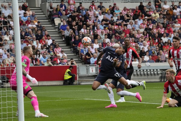 Tottenham's Cristian Romero, 2nd left, scores the opening goal during an English Premier League soccer match between Brentford and Tottenham Hotspur at the Community Stadium in London, Sunday, Aug. 13, 2023. (AP Photo/Frank Augstein)