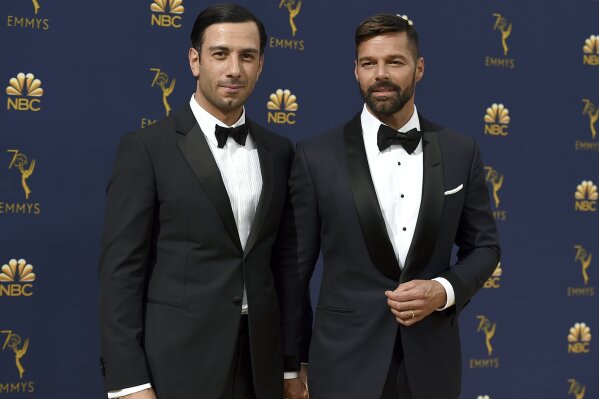 
              FILE - In this Monday, Sept. 17, 2018, file photo, Jwan Yosef, left, and Ricky Martin arrive at the 70th Primetime Emmy Awards at the Microsoft Theater in Los Angeles. Martin announced the arrival of his daughter with an Instagram post showing off the infant’s tiny hands. Martin says he and his artist husband Jwan Yosef have named the girl Lucia. (Photo by Jordan Strauss/Invision/AP, File)
            