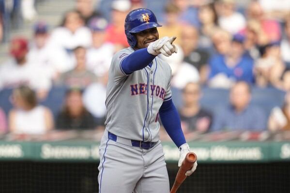 New York Mets' Francisco Lindor gestures to the Cleveland Guardians' dugout as he comes up to bat in the first inning of a baseball game Monday, May 20, 2024, in Cleveland. (AP Photo/Sue Ogrocki)