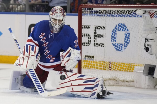 New York Rangers goaltender Igor Shesterkin makes a save during the second period in Game 1 of an NHL hockey Stanley Cup first-round playoff series against the Washington Capitals, Sunday, April 21, 2024, in New York. (AP Photo/Seth Wenig)