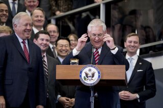 
              In this Feb. 2, 2017 file photo, Secretary of State Rex Tillerson, accompanied by accompanied by State Department Undersecretary for Political Affairs Tom Shannon, left, takes the podium to speak to State Department employees upon arrival at the State Department in Washington. Shannon told agency staffers on Thursday that he will retire as soon as a successor for his Senate-confirmed post is chosen and ready to assume the job.  (AP Photo/Andrew Harnik)
            