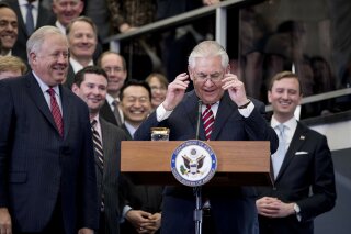 In this Feb. 2, 2017 file photo, Secretary of State Rex Tillerson, accompanied by accompanied by State Department Undersecretary for Political Affairs Tom Shannon, left, takes the podium to speak to State Department employees upon arrival at the State Department in Washington. Shannon told agency staffers on Thursday that he will retire as soon as a successor for his Senate-confirmed post is chosen and ready to assume the job. (AP Photo/Andrew Harnik)