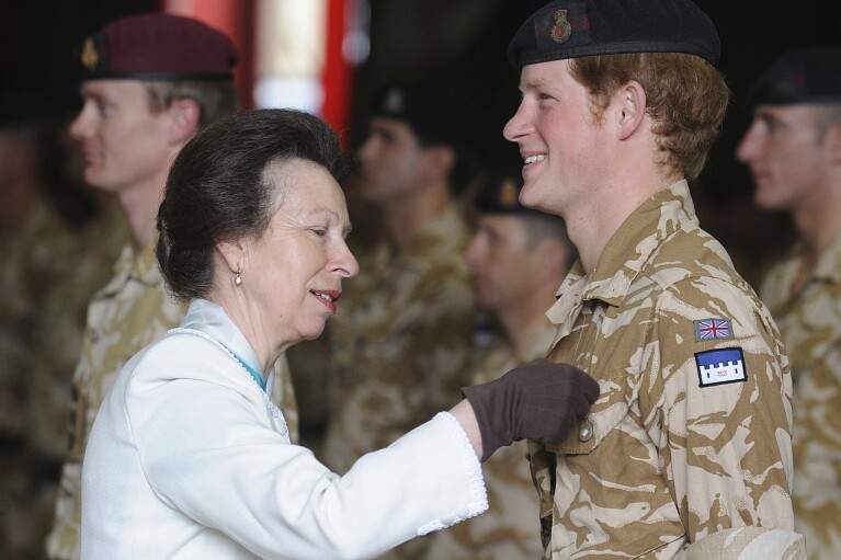 Britain's Princess Anne, left, presents Prince Harry with his campaign medal, in Windsor, England, Monday May 5, 2008. The 23-year-old Prince, known as Lieutenant Wales, is among around 160 members of the Household Cavalry who served in Afghanistan this winter to receive the decoration. (AP Photo/John Stillwell, pool)
