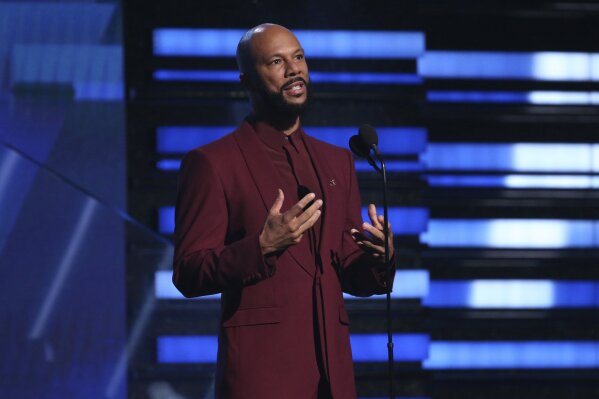 FILE - In this Jan. 26, 2020 file photo, Common introduces a performance at the 62nd annual Grammy Awards in Los Angeles. The Grammy and Academy Award winning rapper and his criminal justice reform organization Imagine Justice has launched a campaign with dozens of advocacy and activist groups calling attention to the threat coronavirus poses on millions of people jailed or imprisoned in the U.S. (Photo by Matt Sayles/Invision/AP, File)