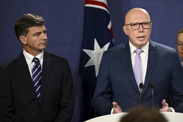 Opposition Leader Peter Dutton unveils details of proposed nuclear energy plan as Shadow Treasurer Angus Taylor, left, looks on during a press conference at the Commonwealth Parliamentary Offices in Sydney, Wednesday, June 19, 2024. Australia's main opposition party has announced plans to build Australia's first nuclear power plants by 2037, arguing the government's policies for decarbonizing the economy with renewable energy sources including solar, wind turbines and green hydrogen would not work. (Bianca De Marchi/AAP Image via AP)
