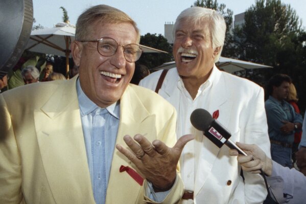 
              FILE - In this Aug. 25, 1992 file photo, Jerry Van Dyke, left, and his brother, Dick, laugh during a party in Los Angeles. Manager said Saturday, Jan. 6, 2018, that Jerry Van Dyke, 'Coach' star and younger brother of comedian Dick Van Dyke, has died in Arkansas at 86.  Manager, John Castonia, said Van Dyke died Friday at his ranch in Hot Spring County. His wife, Shirley Ann Jones, was by his side. (AP Photo/Chris Martinez, File)
            