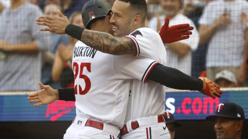 Minnesota Twins' Byron Buxton, left, celebrates his three-run home run against the Chicago White Sox with Carlos Correa in the first inning of a baseball game Friday, July 21, 2023, in Minneapolis. (AP Photo/Bruce Kluckhohn)