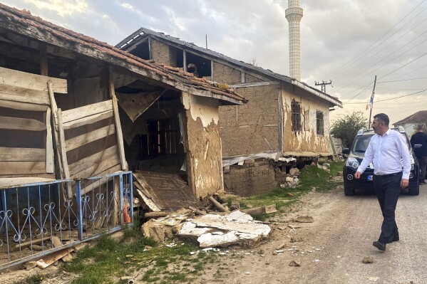 A man looks at the damage caused by a moderately-strong earthquake that struck Tokat province, some 450 kilometers (280 miles) east of the capital, Ankara, Turkey, Thursday, April 18, 2024. The magnitude 5.6 earthquake hit in the town of Sulusaray, in Tokat province, causing damage to some buildings. There was no immediate report of any casualties or serious injuries. (Dia Images via AP)