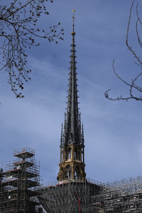 The spire of the Notre Dame de Paris cathedral after the scaffolding removal, Thursday, March 14, 2024 in Paris. Scaffolding has enshrouded Notre Dame Cathedral in Paris since a 2019 fire destroyed its spire and roof and threatened to collapse the whole medieval structure. After an unprecedented international reconstruction effort, the scaffolding is at last starting to peel away. (AP Photo/Michel Euler)