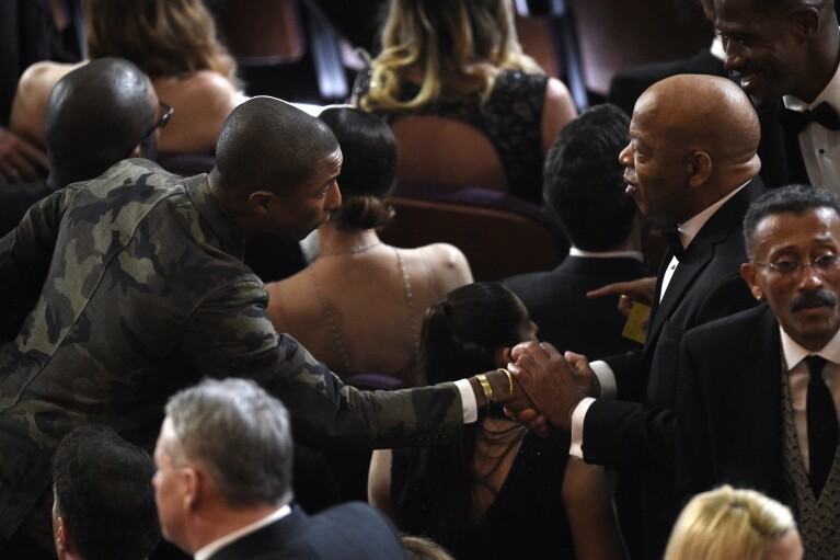 Pharrell Williams, left, greets civil rights activist John Lewis in the audience at the Oscars on Sunday, Feb. 24, 2019, at the Dolby Theatre in Los Angeles. (Photo by Chris Pizzello/Invision/AP)