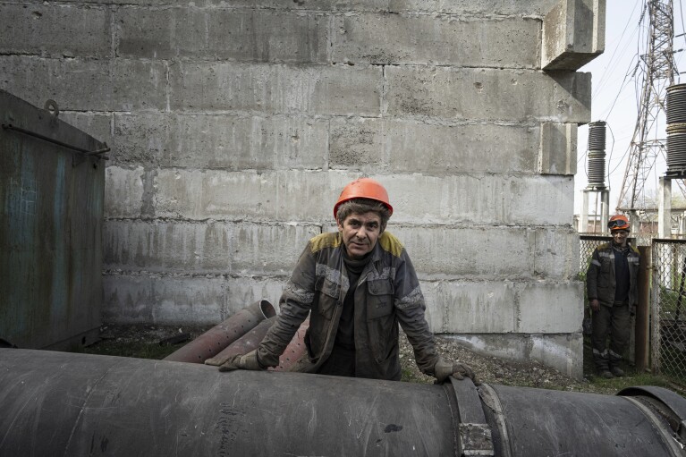 A worker rests near a transformer which was destroyed after a Russian missile attack at DTEK's power plant in Ukraine, on Monday, April 1, 2024. Russia is attacking Ukraine’s energy sector with renewed intensity and alarming accuracy, signaling to Ukrainian officials that Russia is armed with better intelligence and fresh tactics in its campaign to annihilate the country’s power generation capacity. (AP Photo/Evgeniy Maloletka)