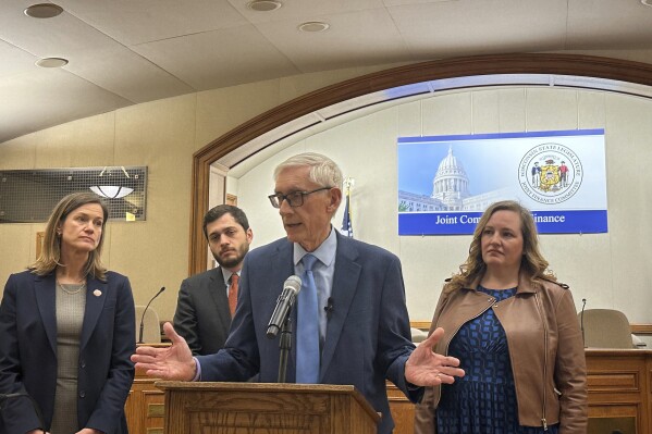 Wisconsin Gov. Tony Evers faults Republicans for not attending a meeting of the Legislature's budget committee the governor called in a failed attempt to get the panel to approve $125 million in funding to combat "forever chemicals" on Tuesday, April 16, 2024, in Madison, Wisconsin. Evers is joined by Democratic Reps. Deb Andraca and Tip McGuire and Sen. Kelda Roys. (AP Photo/Scott Bauer)