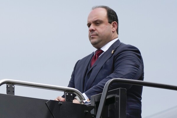FILE - Boris Epshteyn arrives with former President Donald Trump at Ronald Reagan Washington National Airport, Aug. 3, 2023, in Arlington, Va. Police records show that Epshteyn, a longtime aide to Trump, was arrested in 2021 after he was accused of repeatedly groping two women in a nightclub in Scottsdale, Ariz. (AP Photo/Alex Brandon, File)