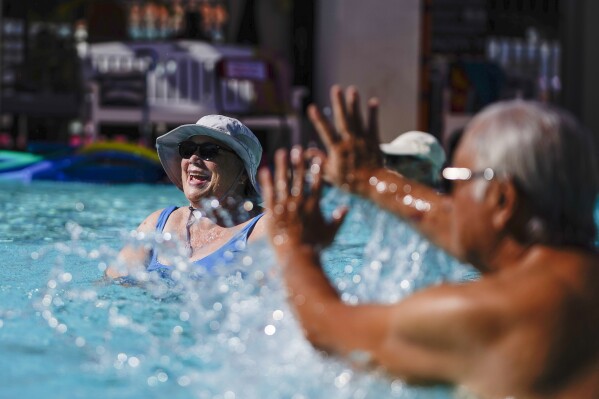 Seniors participate in a morning swim class during a heat wave, Wednesday, July 19, 2023, in Pasadena, Calif. (AP Photo/Ryan Sun)