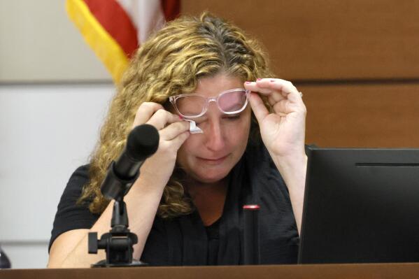 Marjory Stoneman Douglas High School teacher Dara Hass wipes away tears as she testifies in court about the shooting in her classroom during the penalty phase of Marjory Stoneman Douglas High School shooter Nikolas Cruz's trial at the Broward County Courthouse in Fort Lauderdale, Fla., on Tuesday, July 19, 2022. His brother, Nicholas Dworet was also shot, and was killed in the rampage. Cruz previously plead guilty to all 17 counts of premeditated murder and 17 counts of attempted murder in the 2018 shootings.  (Mike Stocker/South Florida Sun Sentinel via AP, Pool)