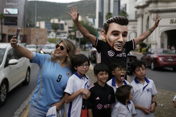 Fans of soccer star Lionel Messi wait for the arrival of the Inter Miami soccer team, outside a hotel in Monterrey, Mexico, Tuesday, April 9, 2024. Inter Miami will face Monterrey in a CONCACAF Champions Cup quarter final second leg soccer match on Wednesday. (AP Photo/Eduardo Verdugo)