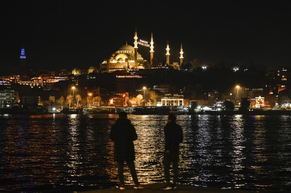 Lights message installed in between the minarets of the Suleymaniye mosque reads in Turkish "Ramadan is the month of Quran" ahead of the Muslim holy month of Ramadan in Istanbul, Turkey, Sunday, March 10, 2024. (AP Photo/Emrah Gurel)