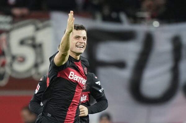 Leverkusen's Granit Xhaka celebrates after scoring the opening goal the German Bundesliga soccer match between Bayer 04 Leverkusen and 1. FSV Mainz 05 at the BayArena in Leverkusen, Germany, Friday, Feb. 23, 2024. (AP Photo/Martin Meissner)