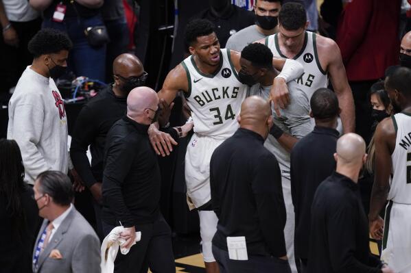 Milwaukee Bucks' Giannis Antetokounmpo (34) is helped off the court after he and Atlanta Hawks' Clint Capela fell during the second half of Game 4 of the NBA basketball Eastern Conference finals Tuesday, June 29, 2021, in Atlanta. (AP Photo/Brynn Anderson)