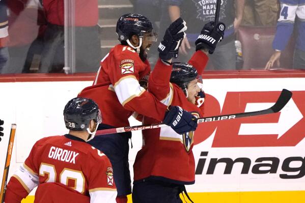 Florida Panthers left wing Anthony Duclair, left, celebrates with defenseman Brandon Montour, right, after Montour scored against the Toronto Maple Leafs in overtime of an NHL hockey game Saturday, April 23, 2022, in Sunrise, Fla. The Panthers won 3-2. (AP Photo/Lynne Sladky)