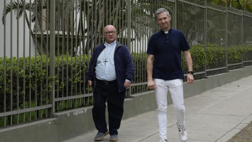 Vatican investigators, Archbishop Charles Scicluna, from Malta, left, and Monsignor Jordi Bertomeu, from Spain, walk outside of the Nunciatura Apostolica during a break from meeting with people who allege abuse by the Catholic lay group Sodalitium Christianae Vitae (SCV) in Lima, Peru, Tuesday, July 25, 2023. The investigators began an audit of the SCV with interrogations of its representatives, alleged victims and journalists who have investigated charges against the brotherhood of alleged sexual abuse and financial corruption. (AP Photo/Martin Mejia)