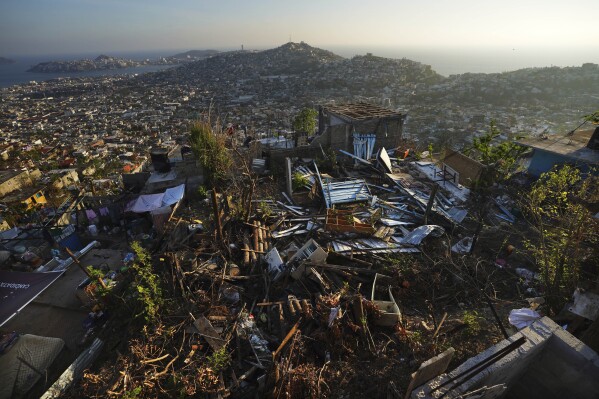 An aerial view of homes destroyed by Hurricane Otis, in Alta Cuauhtemoc, in Acapulco, Mexico, Thursday, Nov. 9, 2023. Nearly three weeks after the Category 5 hurricane devastated this Pacific port, leaving at least 48 people dead and the city’s infrastructure in tatters, the cleanup continues. (AP Photo/Marco Ugarte)