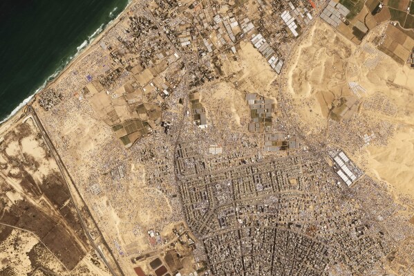 This satellite image from Planet Labs PBC shows tents and other makeshift housing built up around the area of the Tel al-Sultan refugee camp Saturday, April 20, 2024. (Planet Labs PBC via AP)