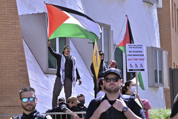 Pro-Palestinian demonstrators wave flags outside the Stata Center at MIT, Thursday, May 9, 2024, in Cambridge, Mass. (AP Photo/Josh Reynolds)