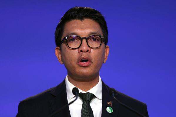 FILE — Madagascar's President Andry Rajoelina speaks during the UN Climate Change Conference COP26 in Glasgow, Scotland, Tuesday, Nov. 2, 2021. A court in Madagascar has convicted two French citizens of having plotted a failed coup against Rajoelina and sentenced them to 10 years and 20 years of forced labor. (Adrian Dennis/Pool Photo via AP File)