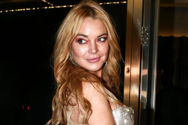 FILE - Actress Lindsay Lohan appears at the opening night of the Lohan Nightclub in Athens, Greece, Oct. 16, 2016. Lohan has told her followers on Instagram that she's engaged to boyfriend Bader Shammas. The 35-year-old ‘Mean Girls’ star has been based in the skyscraper-studded city of Dubai for several years. (AP Photo/Yorgos Karahalis, File)