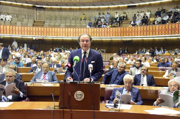 In this photo released by the Pakistan Finance Ministry Press Service, Pakistan's Finance Minister Muhammad Aurangzeb speaks and parented, the Federal Budget before the National Assembly of Pakistan, in Islamabad, Pakistan, Wednesday, June. 12, 2024. Pakistan's new gov't presents its first budget in Parliament as it seeks new long-term IMF bailout. (Pakistan Foreign Ministry Press Service via AP)