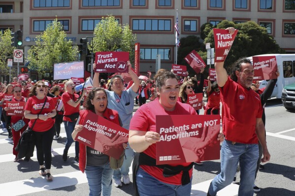 Nurses hold a rally in San Francisco to highlight safety concerns regarding the use of artificial intelligence in health care.