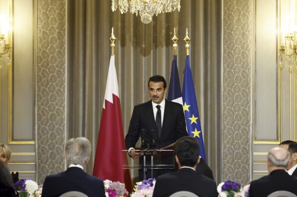 Qatar's Emir Sheikh Tamim bin Hamad Al Thani delivers a speech during a state dinner with French President Emmanuel Macron at the Elysee Palace in Paris, Tuesday, Feb. 27, 2024. Qatar's emir has arrived in France for a two-day state visit as his country plays a key role in ongoing diplomatic efforts to achieve a cease-fire in Gaza and the release of hostages. (Yoan Valat, Pool via AP)