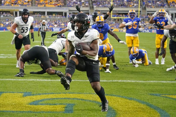 Cincinnati running back Corey Kiner scores a touchdown against Pittsburgh during the first half of an NCAA college football game in Pittsburgh on Saturday, Sept. 9, 2023. (AP Photo/Gene J. Puskar)