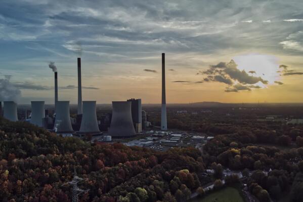 FILE - The sun sets behind a coal-fired power plant in Gelsenkirchen, Germany, Oct. 22, 2022. A new report from doctors and other health experts says the world's fossil fuel addiction is making the world sicker and is killing people. (AP Photo/Michael Sohn, File)