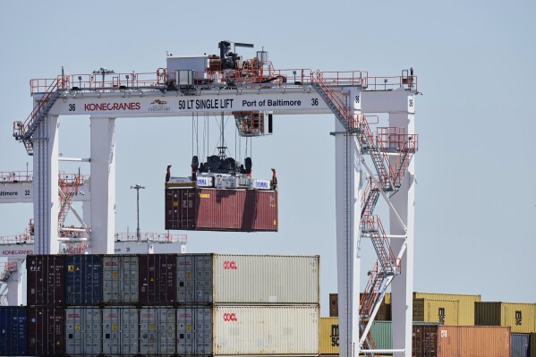 A crane lifts a container at the Port of Baltimore, Wednesday, April 9, 2025, in Baltimore. (AP Photo/Stephanie Scarbrough)