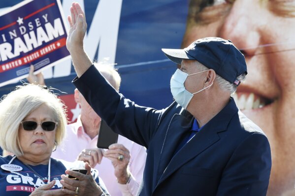 U.S. Sen. Lindsey Graham, R-S.C., waves as he arrives at a campaign rally on Saturday, Oct. 31, 2020, in Conway, S.C. (AP Photo/Meg Kinnard)