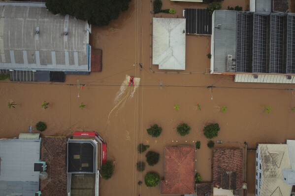 Streets are flooded after heavy rain in Sao Sebastiao do Cai, Rio Grande do Sul state, Brazil, Thursday, May 2, 2024. (AP Photo/Carlos Macedo)