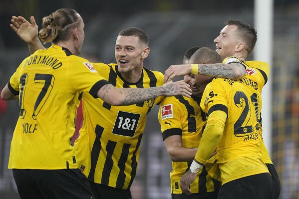 Dortmund's Marco Reus, right, celebrates after scoring his side's sixth goal during the German Bundesliga soccer match between Borussia Dortmund and 1.FC Cologne in Dortmund, Germany, Saturday, March 18, 2023. (AP Photo/Martin Meissner)