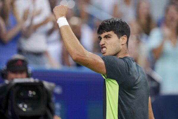 Carlos Alcaraz, of Spain, reacts after winning a point against Novak Djokovic, of Serbia, during the men's singles final of the Western & Southern Open tennis tournament, Sunday, Aug. 20, 2023, in Mason, Ohio. (AP Photo/Aaron Doster)