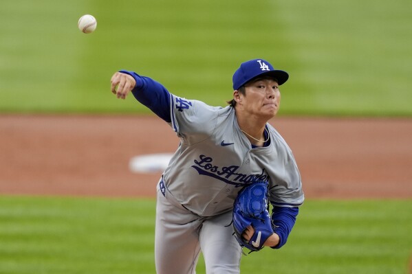 Los Angeles Dodgers starting pitcher Yoshinobu Yamamoto throws during the first inning of a baseball game against the Washington Nationals at Nationals Park, Thursday, April 25, 2024, in Washington. (AP Photo/Alex Brandon)