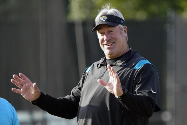 Jacksonville Jaguars head coach Doug Pederson greets players as they arrive at an NFL football practice, Saturday, July 30, 2022, in Jacksonville, Fla. (AP Photo/John Raoux)