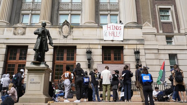 Students with the Gaza Solidarity Encampment block the entrance of Hamilton Hall at Columbia University after taking it over on Tuesday, April 30, 2024 in New York. (Marco Postigo Storel via AP)