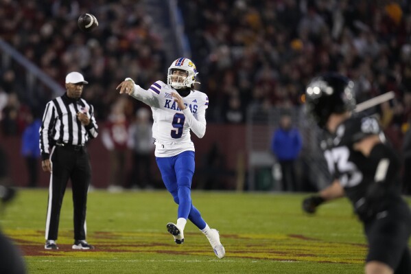 Kansas quarterback Jason Bean (9) throws a pass during the first half of an NCAA college football game against Iowa State, Saturday, Nov. 4, 2023, in Ames, Iowa. (AP Photo/Charlie Neibergall)