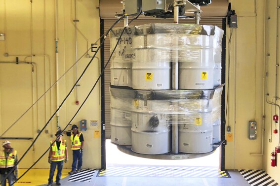 FILE - In this April 9, 2019, photo provided by Los Alamos National Laboratory, barrels of radioactive waste are loaded for transport to the Waste Isolation Pilot Plant, marking the first transuranic waste loading operations in five years at the Radioactive Assay Nondestructive Testing (RANT) facility in Los Alamos, N.M. A report from independent federal investigators Wednesday, July 19, 2023, said the price tag for cleaning up waste at the laboratory is rising and federal officials need to do more to track costs and progress of the $7 billion effort. (Nestor Trujillo/Los Alamos National Laboratory via AP, File)