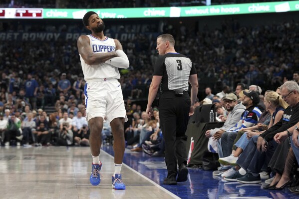 Los Angeles Clippers forward Paul George gestures to the crowd after shooting a 3-point basket during the first half of Game 4 of an NBA basketball first-round playoff series against the Dallas Mavericks, Sunday, April 28, 2024, in Dallas. (AP Photo/Jeffrey McWhorter)