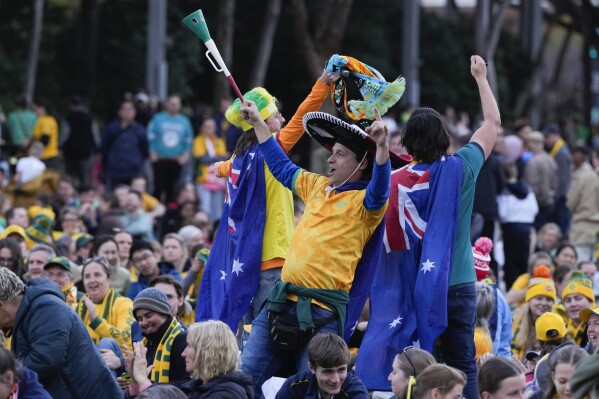 Australian supporters react at a fan zone outside Stadium Australia where the Australia versus France Women's World Cup quarterfinal soccer match is been shown on giant screens from Brisbane ahead of the England and Colombia quarterfinal in Sydney, Australia, Saturday, Aug. 12, 2023. (AP Photo/Rick Rycroft)