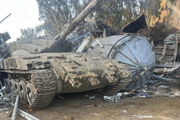 In this photo provided by the Israeli police, an Israeli tank that was stolen from a military zone is seen in a junkyard near Haifa, Israel, Wednesday, Sept. 20, 2022. Israeli authorities are trying to figure out how the tank was stolen from a military training zone and taken to the junkyard in northern Israel. The army said that the tank was unarmed and had been out of service for many years. (Israeli Police via AP)