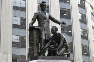 A statue that depicts a freed slave kneeling at Abraham Lincoln's feet rests on a pedestal, Thursday, June 25, 2020, in Boston. The statue in Boston is a copy of the Emancipation Memorial, also known as the Emancipation Group and the Freedman's Memorial, that was erected in Lincoln Park, in Washington, D.C., in 1876. Three years later, the copy was installed in Boston. Calls are mounting for the removal of both statues. (AP Photo/Steven Senne)